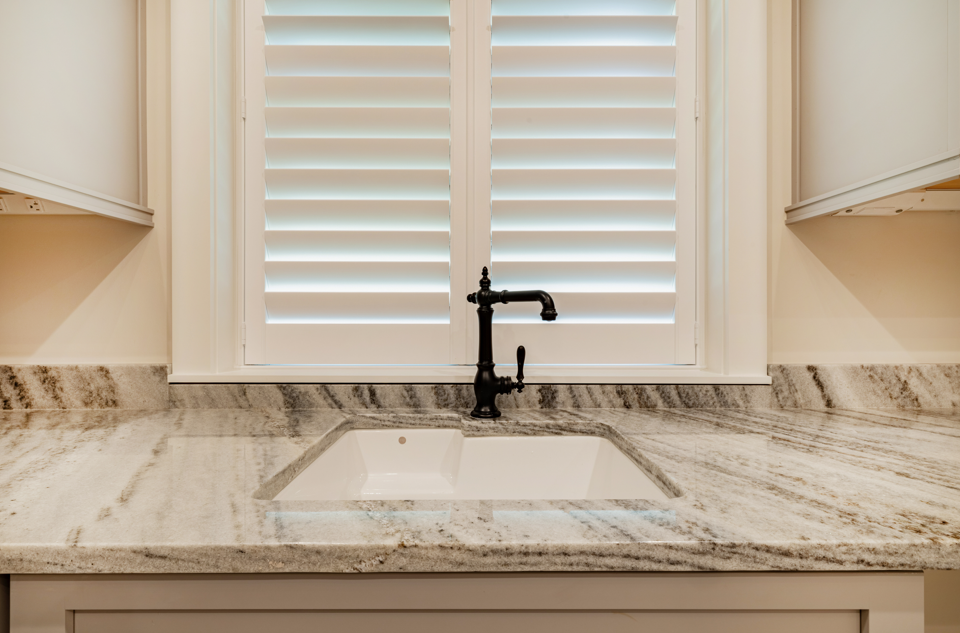 Newly installed bathroom countertops with a small modern sink in a clean, updated interior space.