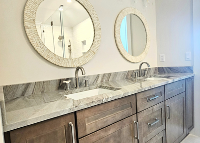 Newly installed bathroom countertops with two modern sinks in a clean, contemporary double-vanity space.